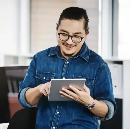 A man using a tablet to save time to consolidate their accounts.