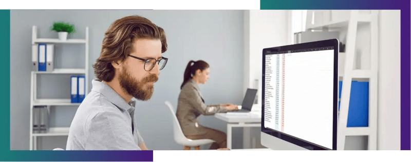 A man using software to calculate his companies accounts easily.
