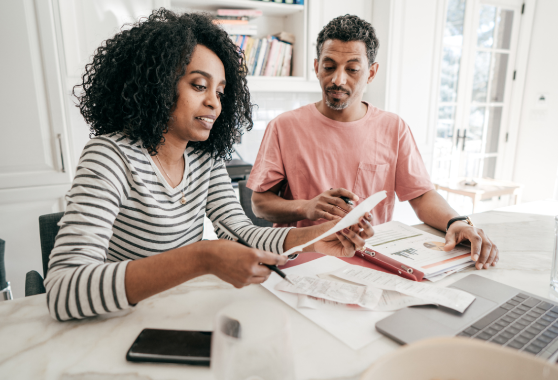 Two people trying to streamline year end closing and financial planning with business forecasting software. 