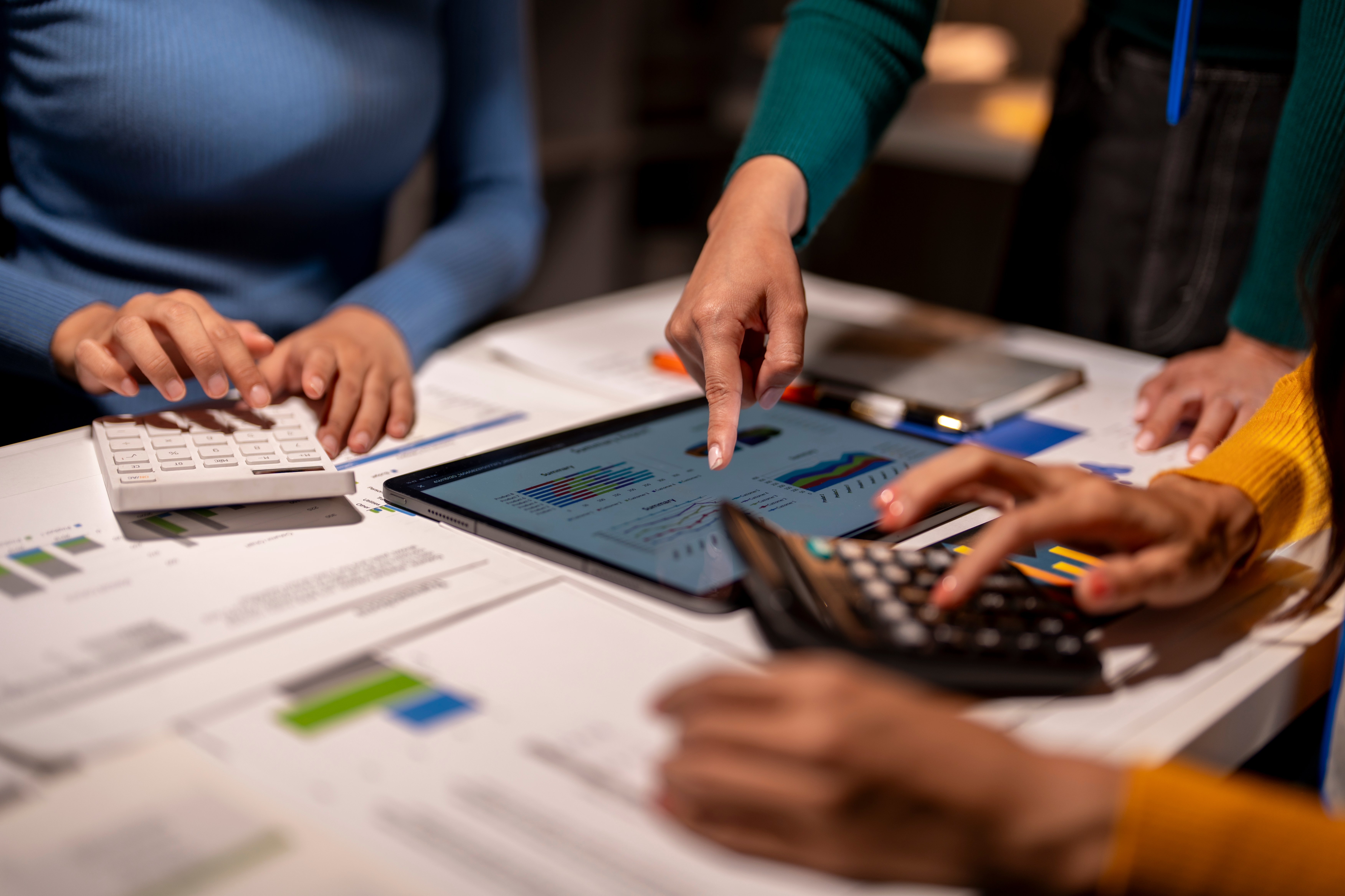 Business team analysing financial charts and data on a budgeting software for informed decision-making.