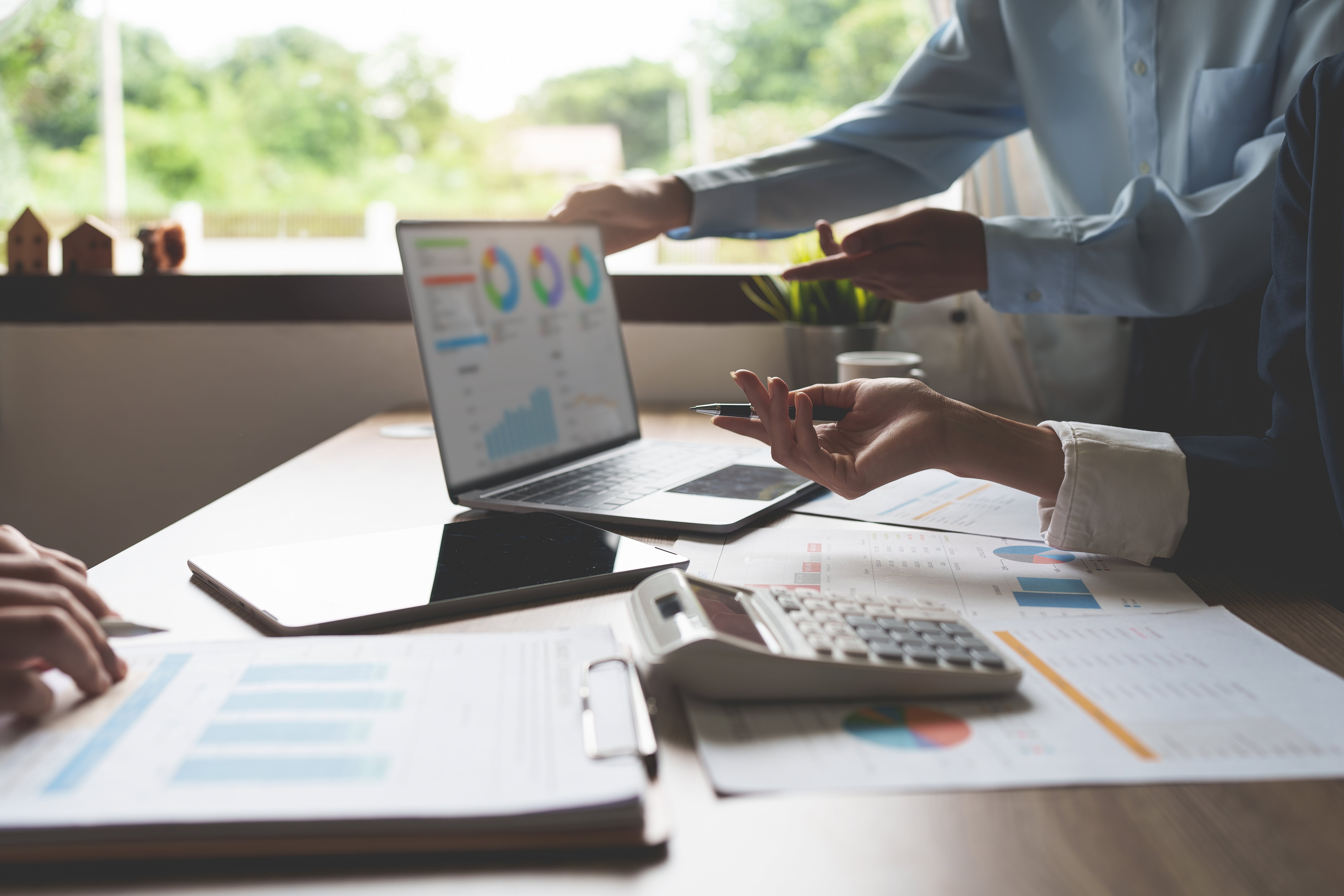 Two business professionals doing collaborative scenario planning in universities needed to reduce financial risk and improve decision-making.
