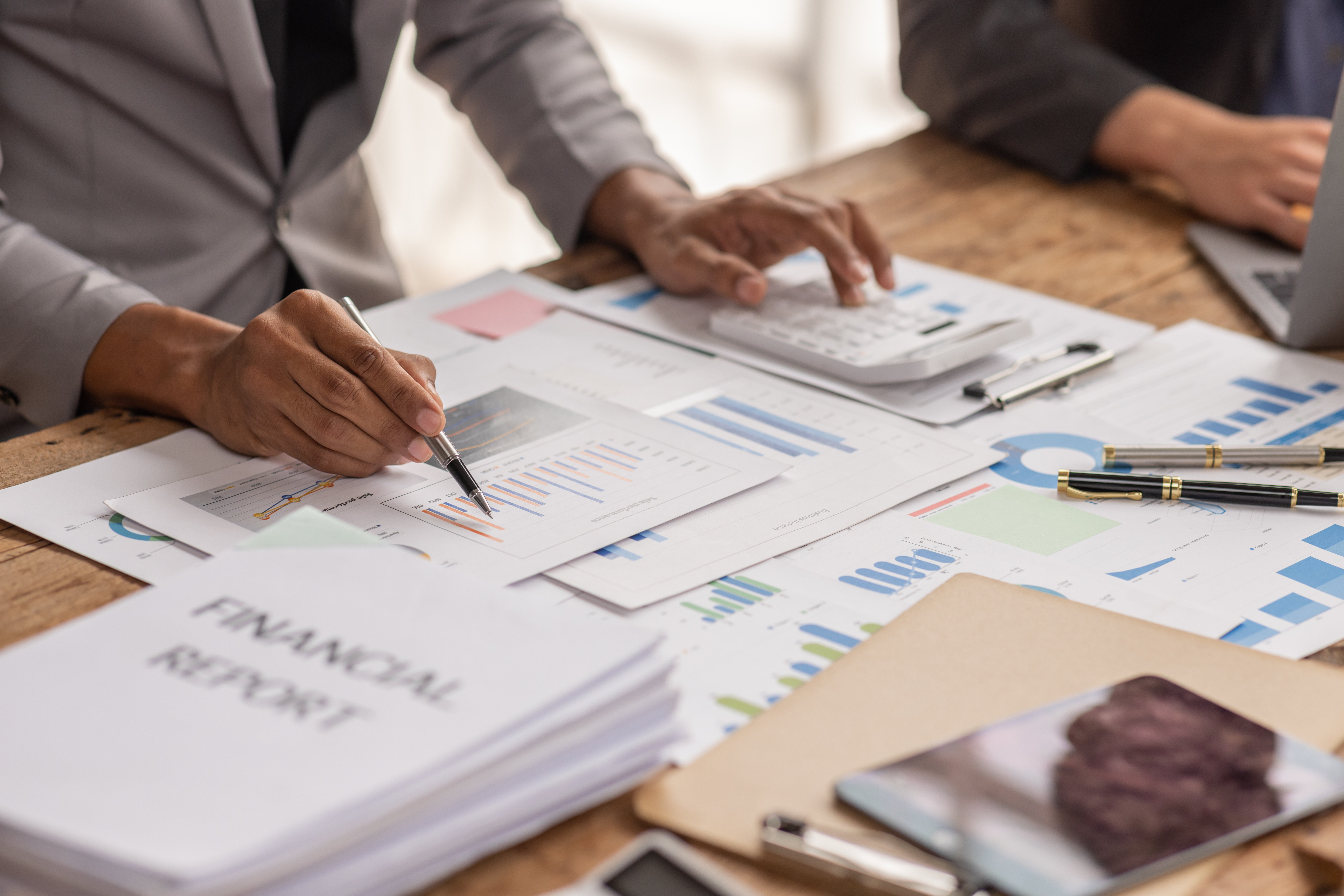 University finance professionals reviewing forecasts and financial data, demonstrating the value of budgeting software for planning and analysis.